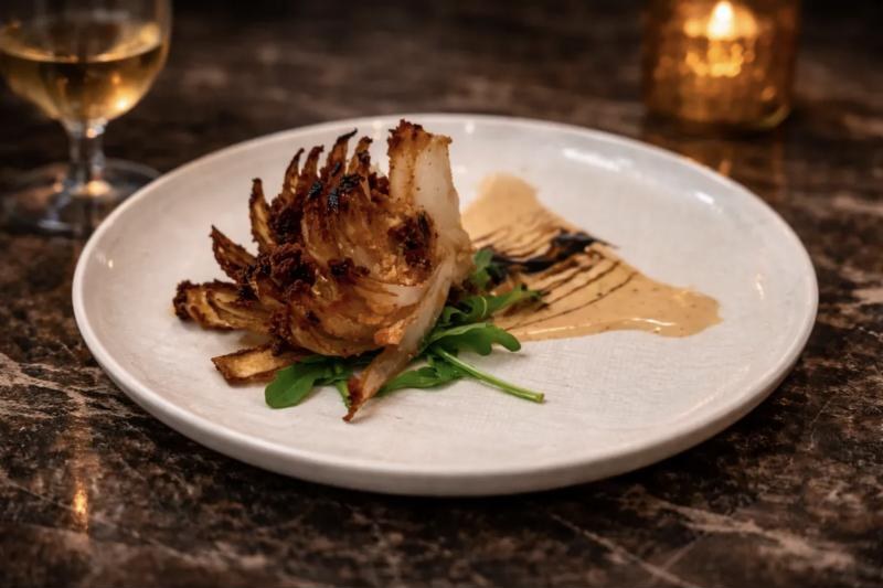Golden blooming onion with arugula and aioli