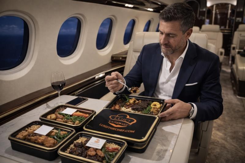 A traveler dining on Luigi The Chef meals aboard a private jet