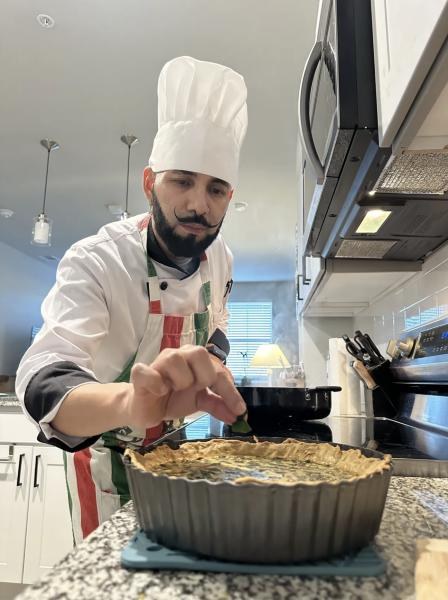 Chef Luigi finishing a homemade quiche in a client's kitchen